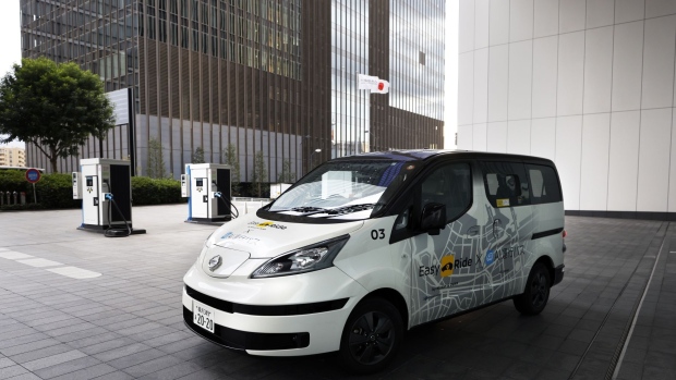 A safety driver behind the wheel of a Nissan robotaxi.