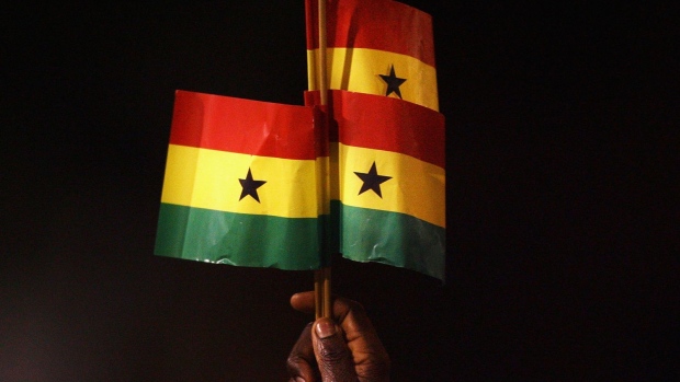 A Ghana fan holds up Ghanaian flags in London.