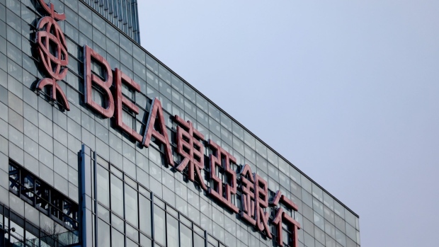 Signage for The Bank of East Asia (BEA) Ltd. is displayed atop of a building in the central business district of Beijing, China, on Thursday, March 14, 2019. China is planning to approve new rules for foreign investment in the country this week, a sweeping overhaul of regulations that will affect corporate titans from Ford to Alibaba and Tencent. Photographer: Giulia Marchi/Bloomberg