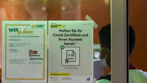 A sign for the requirement of a Covid-19 vaccination certificate outside a Subway Restaurants fast-food outlet in Bern, Switzerland, on Thursday, Sept. 16, 2021. Switzerland, which has stood out among European neighbors for its generally more laissez-faire approach to the pandemic, is joining the ranks of countries now increasing pressure on the unvaccinated.