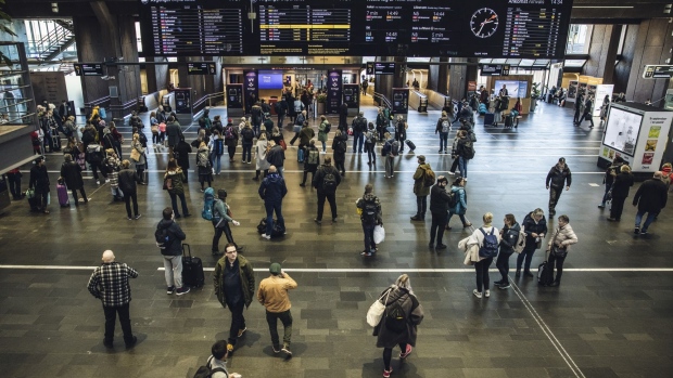 Commuters and travelers on the concourse at the central railway station in Oslo. Photographer: Odin Jaeger/Bloomberg