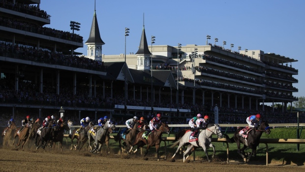 Horses round the first turn at Churchill Downs during the 147th Running of the Kentucky Derby in Louisville, Kentucky, U.S., on Saturday, May 1, 2021. The Kentucky Derby's return to its traditional early May timing follows a muted 2020, when the race was postponed to September due to the pandemic.