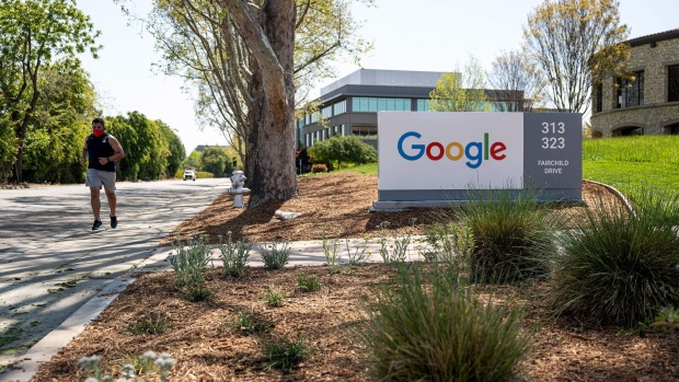 A person wearing a protective masks runs past a Google campus in Mountain View, California, U.S., on Wednesday, April 21, 2021. Silicon Valley has the lowest office vacancy rate in the U.S., even as technology companies embrace remote work. Photographer: David Paul Morris/Bloomberg