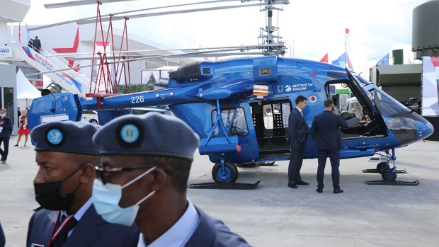 KUBINKA, RUSSIA - AUGUST, 23: (RUSSIA OUT) Officers from Rwanda observe the KA-226T military helicopter exposed at the International Military-Technical Forum "Army-2021" at the Partiot Park, on August,23,2021, in Kubinka, outside of Moscow, Russia. President Putin arrived to the Patriot Park to visit an annual national military forum and exhibition. (Photo by Mikhail Svetlov/Getty Images)
