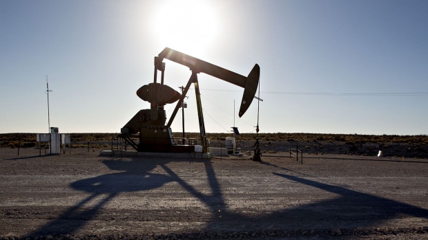 The silhouette of a pumpjack is seen in the Permian Basin near Orla, Texas, U.S., on Friday, March 2, 2018. Chevron, the world's third-largest publicly traded oil producer, is spending $3.3 billion this year in the Permian and an additional $1 billion in other shale basins. Its expansion will further bolster U.S. oil output, which already exceeds 10 million barrels a day, surpassing the record set in 1970. Photographer: Daniel Acker/Bloomberg