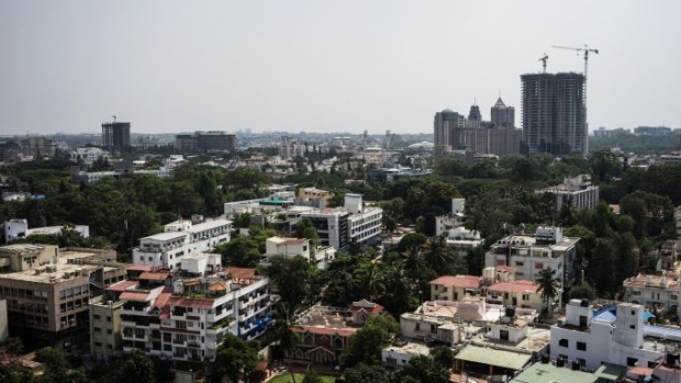 Buildings stand under construction among other commercial and residential property in Bangalore, India on Sunday, May 3, 2015. India's Finance Minister Arun Jaitley is striving for a goods and services levy to subsume a range of federal and state taxes, a step that would make India more of a single market for commerce. Photograph: Sanjit Das/Bloomberg Photographer: Sanjit Das
