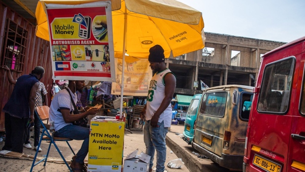 A pedestrian passes by an MTN Group Ltd. bus stop advertisement and roadside kiosk in Lagos, Nigeria, on Monday, Nov. 13, 2017. MTN is focused on laying the groundwork for an initial public offering of its Nigerian business and should complete the process in the next six months, Chief Executive Officer Rob Shuter said. Photographer: Tom Saater/Bloomberg
