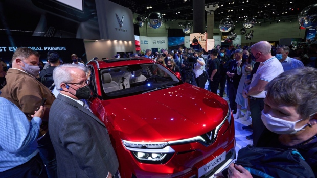 Attendees view the VinFast VF e35 electric vehicle (EV) after a global reveal during AutoMobility LA ahead of the Los Angeles Auto Show in Los Angeles, California, U.S., on Wednesday, Nov. 17, 2021. Covid-19 canceled the Los Angeles Auto Show in 2020 and now that the show is back, some automakers have decided they didn't need it anyway.