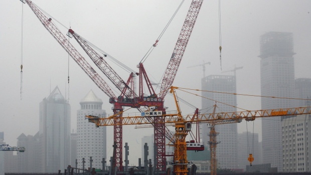 The construction site of the new CCTV headquarters in seen against a foggy city skyline in Beijing, China, Tuesday, July 18, 2006. China's economy grew 11.3 percent in the second quarter, the fastest pace in more than a decade, and the government said it will clamp down on lending and investment. Photographer: NATALIE BEHRING/Bloomberg News
