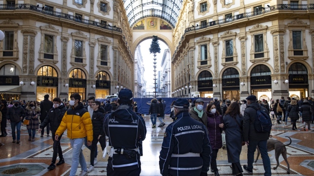 Police officers stand guard in the Vittorio Emanuele II Gallery in Milan, Italy, on Saturday, Nov. 27, 2021. Prime Minister Mario Draghi's government has approved new curbs targeting mainly unvaccinated people in a bid to shield Italy from a surge of coronavirus cases elsewhere in Europe. Photographer: Francesca Volpi/Bloomberg
