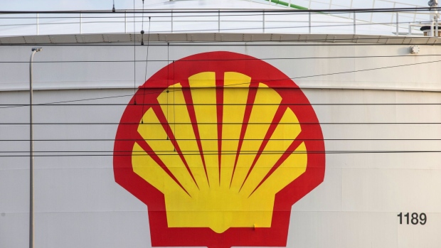 A Royal Dutch Shell Plc logo on an oil silo near overhead railway power lines at the Shell Pernis refinery in Rotterdam, Netherlands, on Tuesday, April 27, 2021. Shell reports first quarter earnings on April 29. Photographer: Peter Boer/Bloomberg