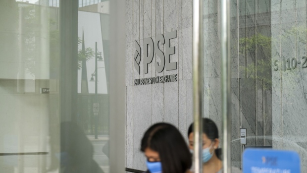People wearing protective masks leave the Philippine Stock Exchange tower in Bonifacio Global City (BGC), Metro Manila, the Philippines, on Tuesday, March 17, 2020. The Philippine stock exchange chief said he plans to reopen the $188 billion market on Thursday, seeking a quick resumption of trading after the country became the first to shut financial markets in response to the widening coronavirus pandemic. Photographer: Veejay Villafranca/Bloomberg