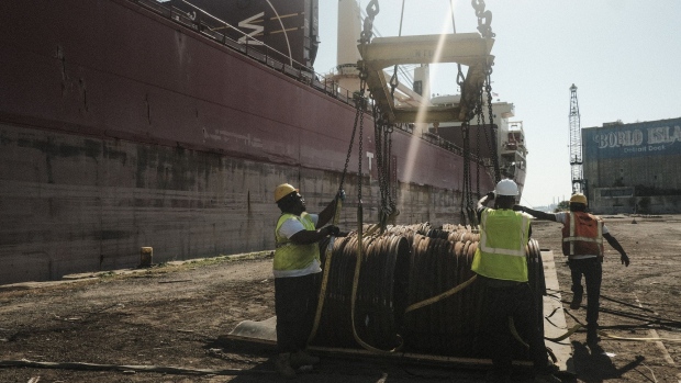 Workers unload bar-in-coil steel from a freight ship in the dockyard at the Port of Detroit in Detroit, Michigan, U.S., on Monday, Sept. 27, 2021. The U.S. Census Bureau is scheduled to release trade balance figures on October 5. Photographer: Matthew Hatcher/Bloomberg