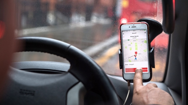 A driver uses the Uber Technologies Inc. ride-hailing service smartphone app to complete passenger drop-off in this arranged photograph in London, U.K., on Friday, Dec. 22, 2017. Uber will be regulated in European Union countries as a transport company after the bloc's top court rejected its claim to be a digital service provider, a decision that could increase legal risks for other gig-economy companies including Airbnb.