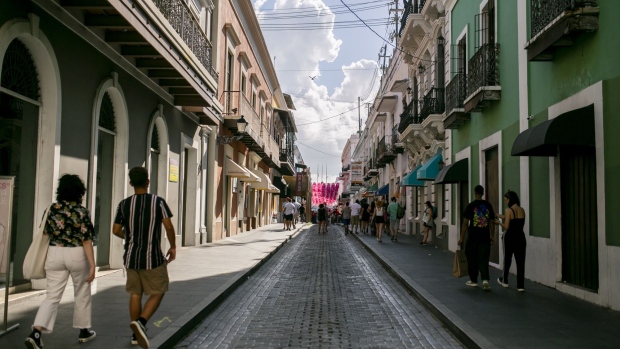 Pedestrians walk through the Old San Juan neighborhood of San Juan, Puerto Rico, on Thursday, May 6, 2021. With Democrats pushing for higher taxes on the richest Americans to fund President Joe Biden's infrastructure and climate initiatives, hedge fund managers are taking refuge in Puerto Rico. Photographer: Xavier Garcia/Bloomberg