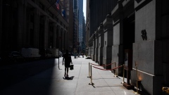A pedestrian walks along Wall Street near the New York Stock Exchange (NYSE) in New York, U.S., on Monday, July 20, 2020. U.S. stocks fluctuated in light trading as investors are keeping an eye on Washington, where lawmakers will begin hammering out a rescue package to replace some of the expiring benefits earlier versions contained. Photographer: Michael Nagle/Bloomberg