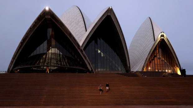 Pedestrians walk down steps at the near deserted Sydney Opera House forecourt during a lockdown imposed due to the coronavirus in Sydney, Australia, on Tuesday, June 29, 2021. Close to half of Australia’s population is now in lockdown as the nation struggles to contain a spread of the delta coronavirus variant. Photographer: Brendon Thorne/Bloomberg