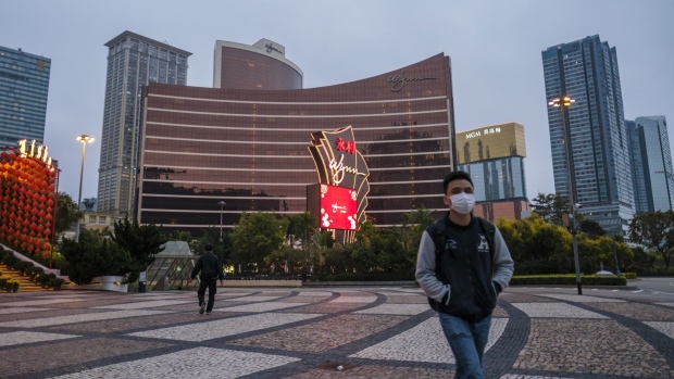 A pedestrian wearing a protective mask walks past Wynn Macau casino resort, operated by Wynn Resorts Ltd., in Macau, China, in the early morning of Wednesday, Feb. 5, 2020. Casinos in Macau, the Chinese territory that's the worlds biggest gambling hub, closed for 15 days as China tries to contain the spread of the deadly coronavirus.