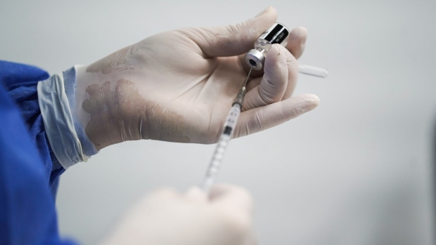 A healthcare worker fills a syringe with a Covid-19 vaccine. Photographer: Nathalia Angarita/Bloomberg