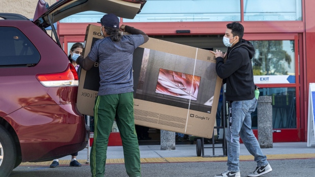 Shoppers load a television into a vehicle at a Best Buy store on Black Friday in San Carlos, California, U.S., on Friday, Nov. 26, 2021. Consumers are finding some of the least-generous Black Friday and Cyber Week deals on record because of inflation, robust demand and diminished product availability.
