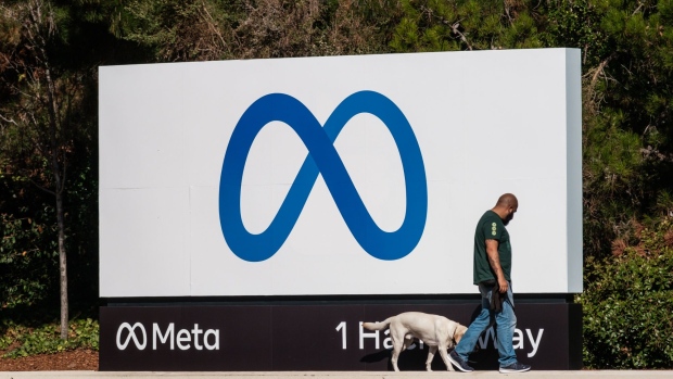 A security dog is walked around signage at Meta Platforms headquarters in Menlo Park, California, U.S., on Friday, Oct. 29, 2021. Facebook Inc. is re-christening itself Meta Platforms Inc., decoupling its corporate identity from the eponymous social network mired in toxic content, and highlighting a shift to an emerging computing platform focused on virtual reality.