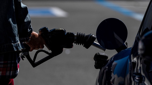A person holds a fuel pump nozzle at a Chevron Corp. gas station in San Francisco, California, U.S., on Thursday, March 11, 2021. Northern Californians are taking to the open road in much greater numbers, an early signal that gasoline demand may be returning a year after the pandemic paralyzed the economy.