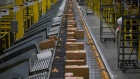 Packages move along a conveyor at an Amazon fulfillment center on Cyber Monday in Robbinsville, New Jersey, U.S., on Monday, Nov. 29, 2021. Adobe Digital Economy Index is expecting Cyber Monday to bring the biggest holiday shopping of the year, with consumers projected to spend between $10.2 billion and $11.3 billion. Photographer: Michael Nagle/Bloomberg