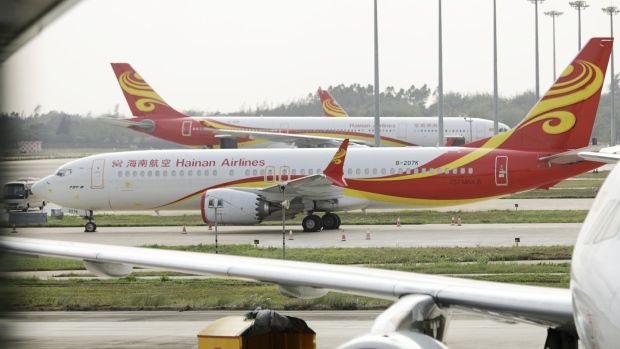 A Boeing Co. 737 Max 8 aircraft operated by Hainan Airlines Holdings Co. stands at Haikou Meilan International Airport in Haikou, Hainan province, China, on Tuesday, March 26, 2019. China suspended a certificate of airworthiness for Boeing's 737 Max jet, saying it needs to review a proposed modification before determining whether the plane is safe to fly after two recent crashes. Photographer: Qilai Shen/Bloomberg