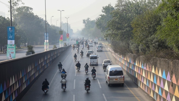 Traffic travels along a highway shrouded in smog in Lahore, Pakistan, on Friday, Dec. 3, 2021. The city of more than 11 million people in Punjab province near the border with India consistently ranks among the worst cities in the world for air pollution. Photographer: Asad Zaidi/Bloomberg
