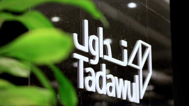A logo in Arabic and English sits on display at the entrance to the Saudi Stock Exchange, also known as Tadawul, in Riyadh, Saudi Arabia, on Sunday, Nov. 4, 2018. A month after the murder of government critic Jamal Khashoggi in the Saudi consulate in Istanbul, bankers say the rewards of doing business with the oil-rich kingdom far outweigh the risks. Photographer: Mohammed Almuaalemi/Bloomberg