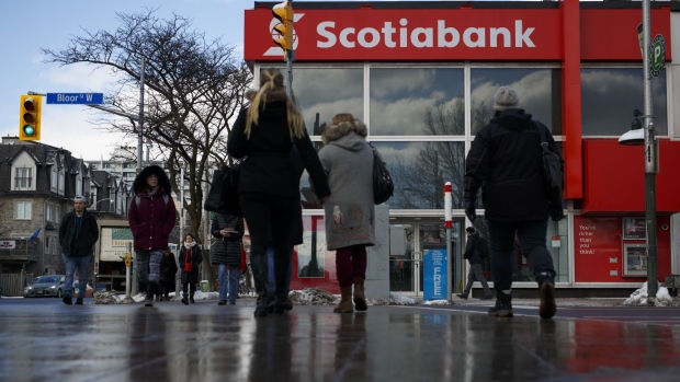 Pedestrians pass in front of a Bank of Nova Scotia branch in Toronto, Ontario, Canada, on Monday, Feb. 12, 2018. Bank of Nova Scotia agreed to buy Canadian money manager Jarislowsky Fraser Ltd. for about C$950 million ($755 million), helping push the bank toward its goal of getting more earnings from wealth management. Photographer: Cole Burston/Bloomberg