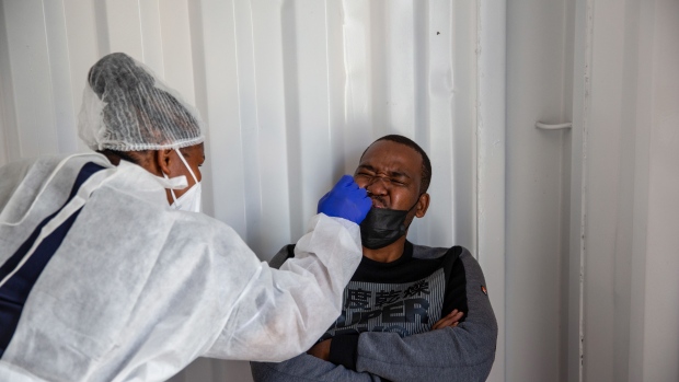 A health worker administers a nasal swab test at a Testaro Covid-19 mobile testing site outside Richmond Corner shopping center in the Milnerton district of Cape Town, South Africa, on Thursday, Dec. 2, 2021. South Africa announced the discovery of a new variant, later christened omicron, on Nov. 25 as cases began to spike and the strain spread across the globe. Photographer: Dwayne Senior/Bloomberg