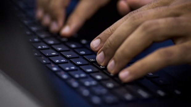 An attendee types on a keyboard during the MarketplaceLIVE Hackathon, sponsored by Digital Realty Trust Inc., in New York, U.S., on Thursday, Sept. 22, 2016. Digital Realty Trust's clients include domestic and international companies ranging from financial services, cloud and information technology services, to manufacturing, energy, gaming, life sciences and consumer products. Photographer: John Taggart/Bloomberg