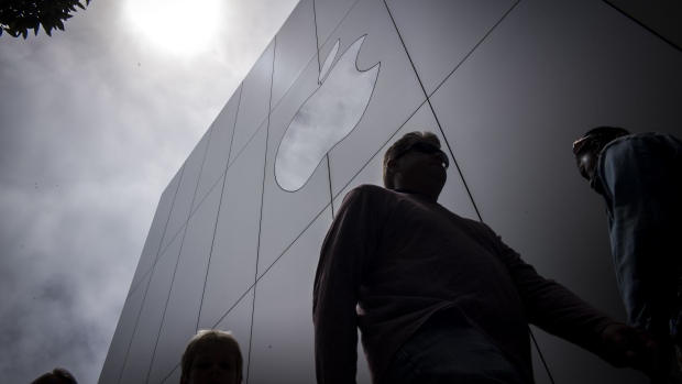 Pedestrians walk past an Apple Inc. store in San Francisco, California, U.S., on Thursday, August 2, 2018. Apple Inc. shares climbed 3 percent on Thursday, pushing it above $1 trillion in market capitalization, the first U.S. company to reach the milestone. Photographer: David Paul Morris/Bloomberg