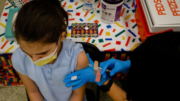 A child receives a dose of the Pfizer-BioNTech COVID-19 vaccine at an elementary school vaccination site for children ages 5 to 11-year-old in Miami, Florida, U.S., on Monday, Nov. 22, 2021. Florida Governor Ron DeSantis signed legislation that would restrict Covid vaccine mandates by employers. Photographer: Eva Marie Uzcategui/Bloomberg