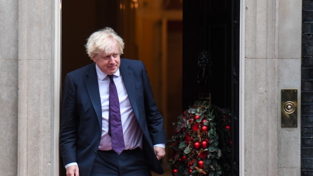 Boris Johnson, U.K. prime minister, prepares to greet Hassanal Bolkiah, Brunei's sultan, at number 10 Downing Street in London, U.K., on Friday, Dec. 3, 2021. The U.K.’s ruling Conservatives won the first electoral contest after an especially bruising period for Boris Johnson's government, holding a parliamentary seat in outer London but with a much-reduced majority.