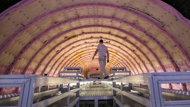 An employee stands inside the passenger cabin of an Airbus A350 twin-engine wide-body jet airliner on the Airbus SE aircraft fuselage assembly line in Hamburg, Germany, on Tuesday, Feb. 27, 2018. Airbus is considering increasing production rates for its best-selling single-aisle A320 jetliners, as airlines around the world place orders for hundreds of planes to meet surging demand for air travel. Photographer: Krisztian Bocsi/Bloomberg