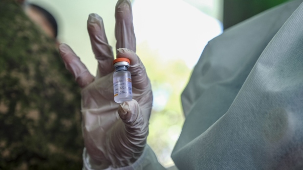 A Philippine Army medical officer holds up a vial of the Sinovac Biotech Ltd. Covid-19 vaccine at the Headquarters Philippine Army Grandstand in Bonifacio, Manila, the Philippines, on Tuesday, March 2, 2021. President Rodrigo Duterte on said Sunday he’s considering further easing virus restrictions once the nation’s vaccine stockpile reaches 2 million, and once shots reach the countryside.