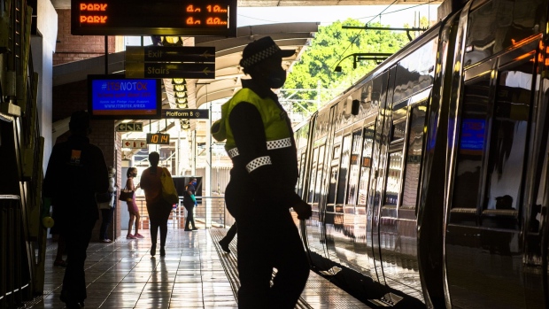 A train guard stands on the platform at the Hatfield Gautrain station in Pretoria, South Africa, on Thursday, Sept. 10, 2020. South Africa’s only high-speed rail network is drawing up a multibillion rand plan to expand outside Johannesburg and Pretoria, joining a potential bonanza of infrastructure projects the government says are key to reviving the economy. Photographer: Waldo Swiegers/Bloomberg