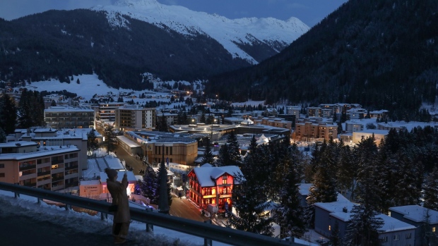 A pedestrian stops to take a smartphone photograph of Davos town ahead of the World Economic Forum (WEF) in Davos, on Jan. 19.