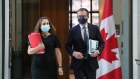 Chrystia Freeland and Tiff Macklem arrive at an Ottawa news conference on Dec. 13, 2021 after releasing the Bank of Canada’s new mandate agreement.