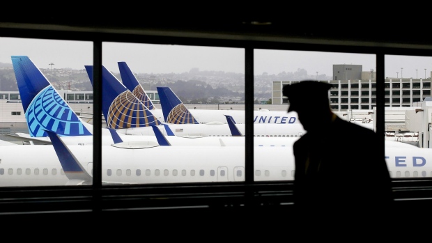 SAN FRANCISCO, CALIFORNIA - APRIL 12: A pilot walks by United Airlines planes as they sit parked at gates at San Francisco International Airport on April 12, 2020 in San Francisco, California. San Francisco International Airport has a seen a huge decline in daily flights since the coronavirus shelter in place. United Airlines, the airport's largest carrier with the most daily flights with 290 flights per day before the start of the COVID-19 pandemic, has reduced their daily flights to 50 per day. (Photo by Justin Sullivan/Getty Images)
