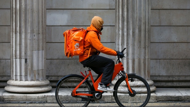 A Food delivery courier for Just Eat Takeaway.com NV in London, U.K., on Wednesday, April 7, 2021. A group of roughly 400 Deliveroo Holding Plc riders are expected to stage protests in five towns and cities across England on Wednesday, the Guardian reports, citing the Independent Workers of Great Britain. Photographer: Hollie Adams/Bloomberg