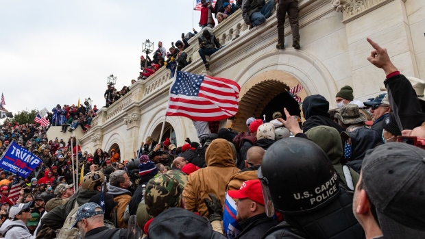 Demonstrators attempt to enter the U.S. Capitol building during a protest in Washington, D.C., U.S., on Wednesday, Jan. 6, 2021. The U.S. Capitol was placed under lockdown and Vice President Mike Pence left the floor of Congress as hundreds of Demonstrators swarmed past barricades surrounding the building where lawmakers were debating Joe Biden's victory in the Electoral College. Photographer: Eric Lee/Bloomberg