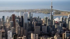 The CN Tower stands among buildings in the downtown skyline in this aerial photograph taken above Toronto, Ontario, Canada, on Monday, Oct. 2, 2017. Toronto housing prices fell for a fourth month in September as sales remained sluggish, particularly in the detached-home segment that has borne the brunt of the correction in Canada's biggest city. Photographer: James MacDonald/Bloomberg