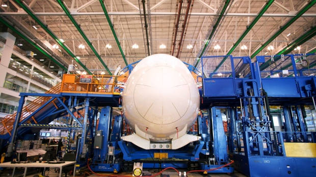 A Boeing Co. Dreamliner 787 plane sits on the production line at the company's final assembly facility in North Charleston, South Carolina, U.S., on Tuesday, Dec. 6, 2016. On the day President-elect Donald Trump lashed out at Boeing Co. for the cost of replacing Air Force One, mechanics and engineers at the planemaker's South Carolina factory were focused on another challenge: making the first 787-10 Dreamliner. The manufacturer is counting on the newest and longest Dreamliner to help turn its marquee carbon-fiber jet into a cash machine. Photographer: Travis Dove/Bloomberg