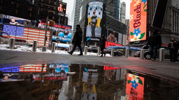 Pedestrians pass in front of the Nasdaq MarketSite during Bumble Inc.'s initial public offering (IPO) in New York, U.S., on Thursday, Feb. 11, 2021. Bumble Inc., the dating app where women make the first move, is targeting to raise as much as $1.8 billion from its U.S. initial public offering after boosting the size of the deal.
