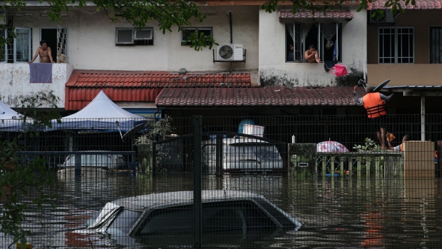 Volunteers deliver food to residents marooned by floodwaters in the Taman Sri Muda township of Shah Alam, Selangor, Malaysia, on Monday, Dec. 20, 2021. Floods hit the Southeast Asian nation annually during the monsoon season, but those at the weekend were the worst in years.