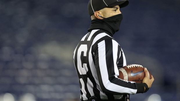 A college football referee wears a face covering due to Covid-19 pandemic during the second half at Navy-Marine Corps Memorial Stadium on November 28, 2020 in Annapolis, Maryland. 