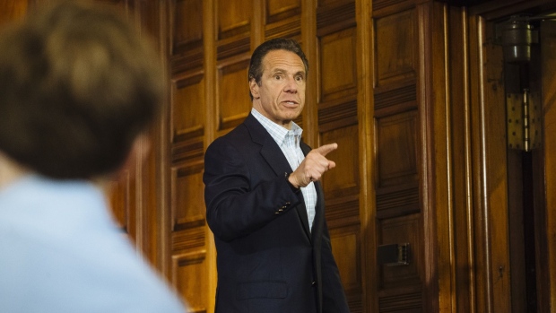 Andrew Cuomo, governor of New York, gestures as he leaves a news conference in the Red Room of the New York State Capitol Building in Albany, New York, U.S., on Sunday, May 17, 2020. Cuomo pleaded on Sunday for more New Yorkers to get tested for the coronavirus as the state reopens for business, engaging in a bit of political theater as he underwent a nasal swab test himself at his daily briefing.
